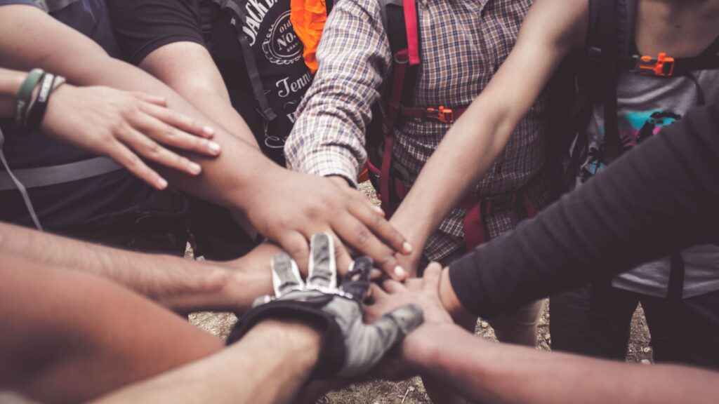 people doing group hand cheer